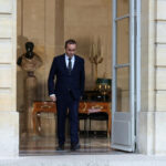 French Prime Minister Sébastien Lecornu exits a government building, symbolizing the implementation of his fiscal plan with potential ripple effects for UK-France economic ties.