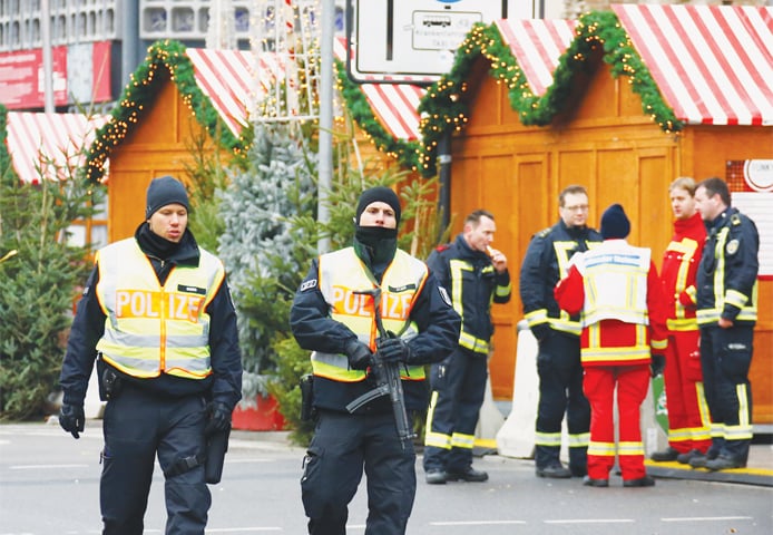 German police and emergency personnel secure a Christmas market in Berlin after thwarting a planned Islamist attack.
