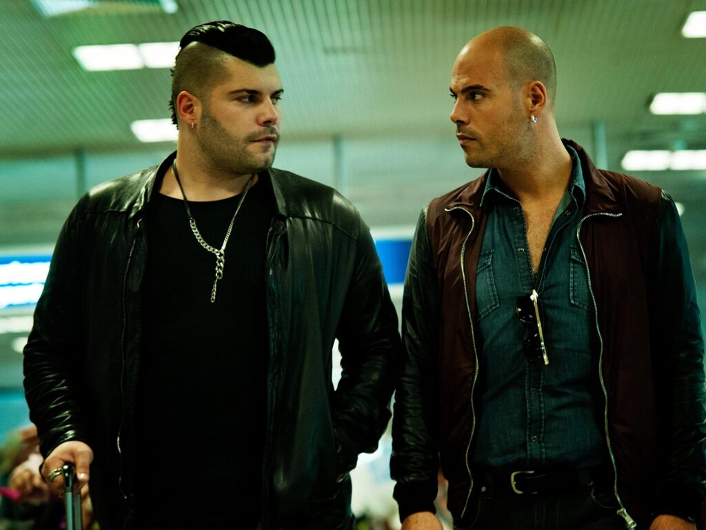 Two actors in a tense scene from the crime drama 'Gomorra,' which has become the focal point of a new French law restricting its discussion.