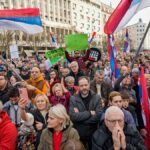 Protesters in Bosnia-Herzegovina rally with Serbian flags, signaling political unrest and potential regional instability following the election of a Dodik-aligned figure.