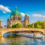 Berlin's iconic landmarks under a sunny sky, symbolizing the city's resilience amid economic concerns.