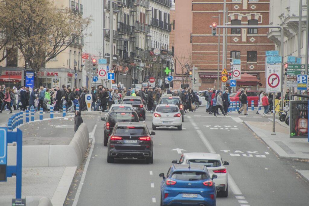 Madrid's central district bustles with traffic as new low-emission zone regulations take effect, granting a one-year grace period for unlicensed polluting vehicles.