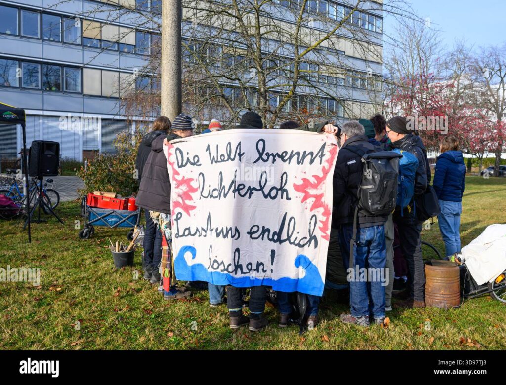 Protesters hold a banner demanding urgent climate action as Germany's top court blocks key climate measures, threatening EU green targets.