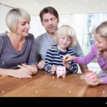 German families are tightening their belts, with household savings surging amid rising living costs, as illustrated by this family saving together.