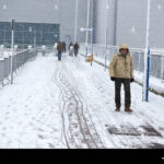 Holiday travelers face delays and disruptions as snow falls at major European airports during the Christmas travel season.