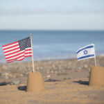 Symbolic sand castles of the U.S. and Israel on a shared beach, representing their collaborative approach to Gaza's reconstruction under U.S. leadership.