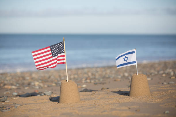 Symbolic sand castles of the U.S. and Israel on a shared beach, representing their collaborative approach to Gaza's reconstruction under U.S. leadership.