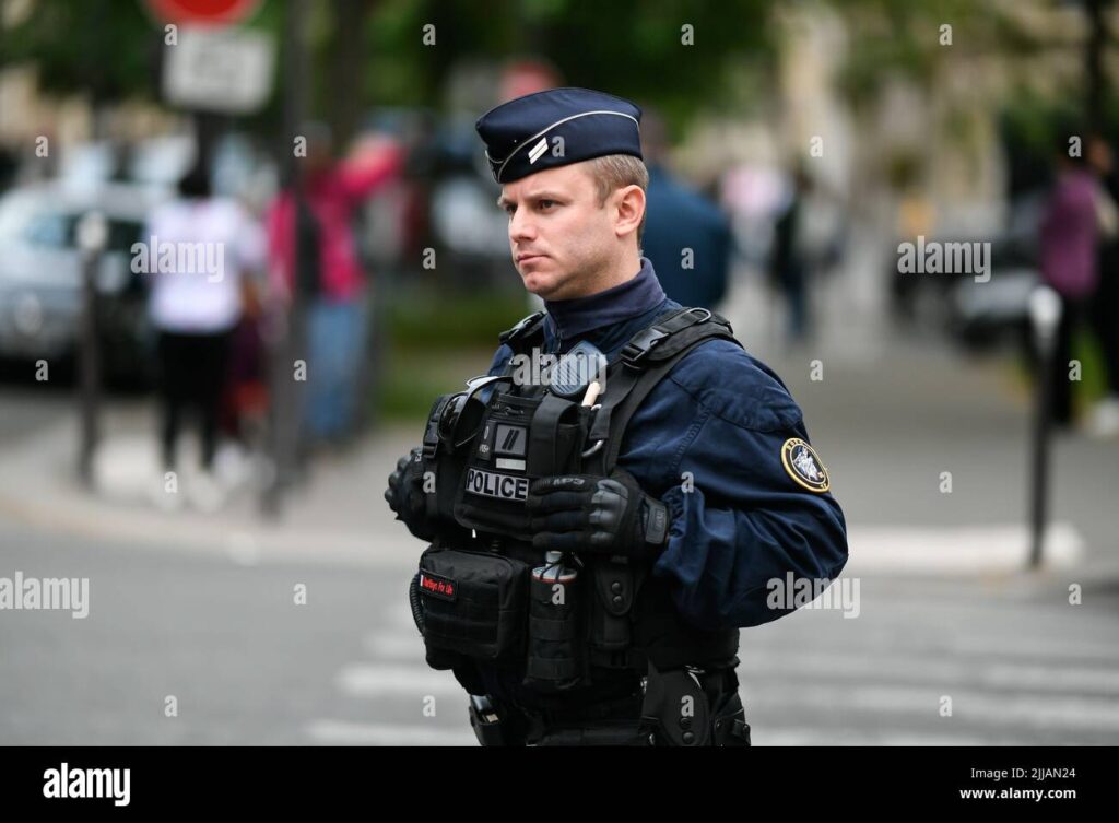 A French police officer on duty, symbolizing the nation's enforcement of legal measures against Russian oligarchs, as part of the EU's broader financial sanctions campaign.