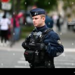 A French police officer on duty, symbolizing the nation's enforcement of legal measures against Russian oligarchs, as part of the EU's broader financial sanctions campaign.
